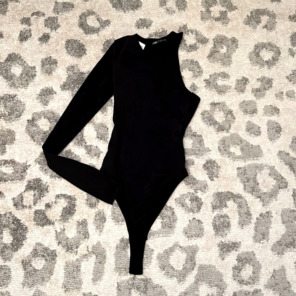 NEW WITH TAG - 1 shoulder black bodysuit. A great closet statement piece